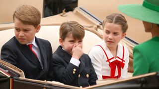 Britain's Prince George of Wales (L), Britain's Prince Louis of Wales (C) and Britain's Princess Charlotte of Wales (R) arrive in a horse-drawn carriage on Horse Guards Parade for the King's Birthday Parade, 'Trooping the Colour', in London on June 17, 2023. The ceremony of Trooping the Colour is believed to have first been performed during the reign of King Charles II. Since 1748, the Trooping of the Colour has marked the official birthday of the British Sovereign. Over 1500 parading soldiers and almost 300 horses take part in the event.
