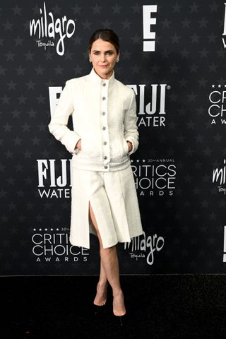 A photo of Keri Russell wearing a Chanel white tweed jacket and matching skirt at the 2025 Critics Choice Awards.