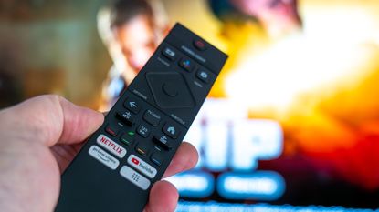 Philips TV remote pointing at screen showing Netflix