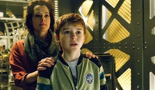 Lost In Space Parker Posey Dr. Smith and Will Robinson look on