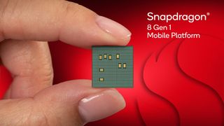 Snapdragon 8 Gen 1 chip held between two fingers