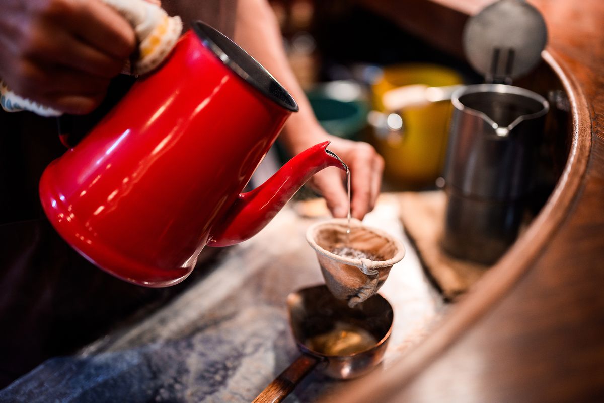 Sample image taken with a Nikon Z 35mm f/1.2 S lens showing a closeup of tea pouring from a teapot into a teacup