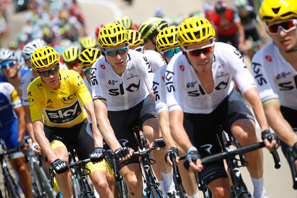 Chris Froome in yellow behind the Sky train.