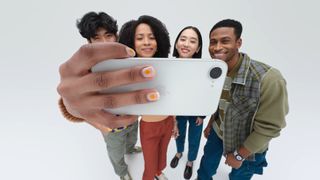 A group of people taking a selfie using the iPhone 16e.