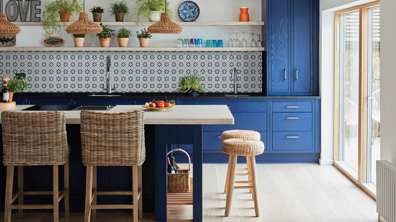 Atlas porcelain blue and white tiles by Ca&#039; Pietra in modern blue kitchen with bar stools around blue kitchen island