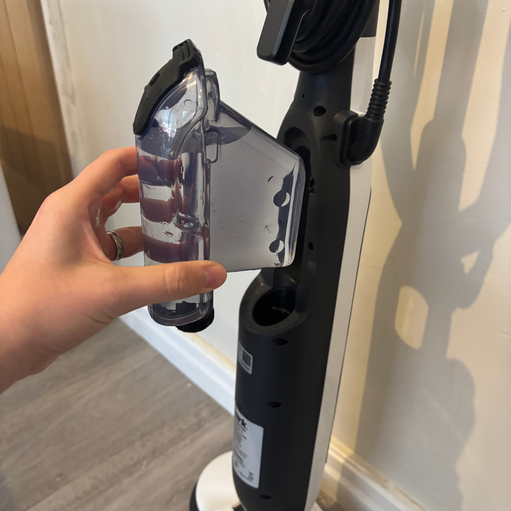 water tank filled with clean water about to be inserted into the Shark Steam & Scrub Automatic