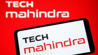 Logo and branding of Tech Mahindra, Google Cloud partner, pictured on a smartphone screen with company logo in background.