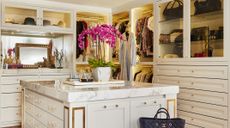 Gold and white closet with island