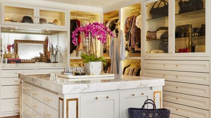 Gold and white closet with island