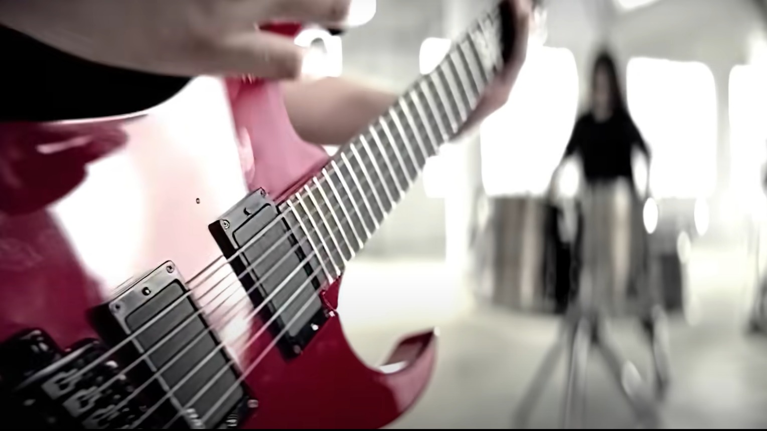 Slipknot Before I Forget music video with a red bass guitar being played