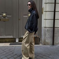 Annabel wears elevated chinos and a black leather jacket.