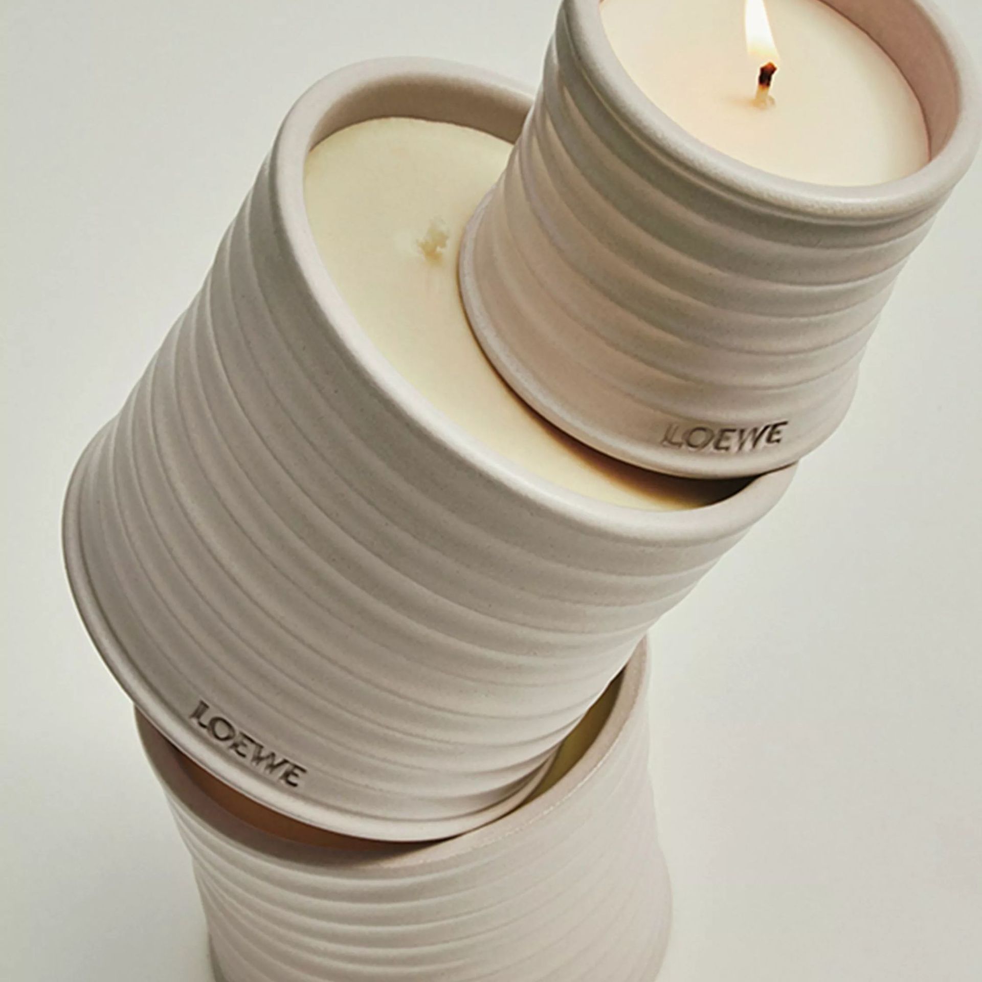 Loewe Oregano Candles against a cream background.