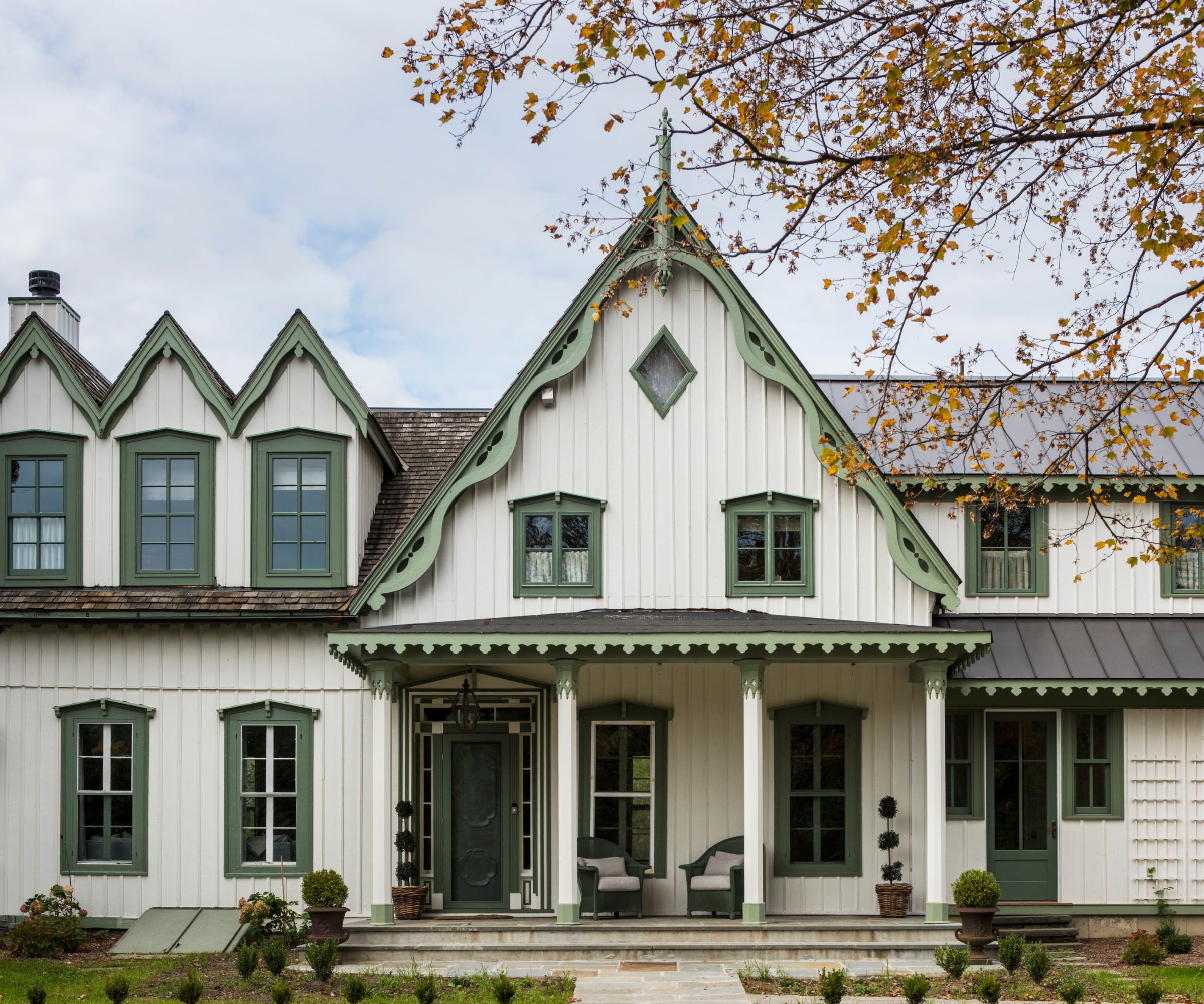 Historic home exterior painted in different shades of green