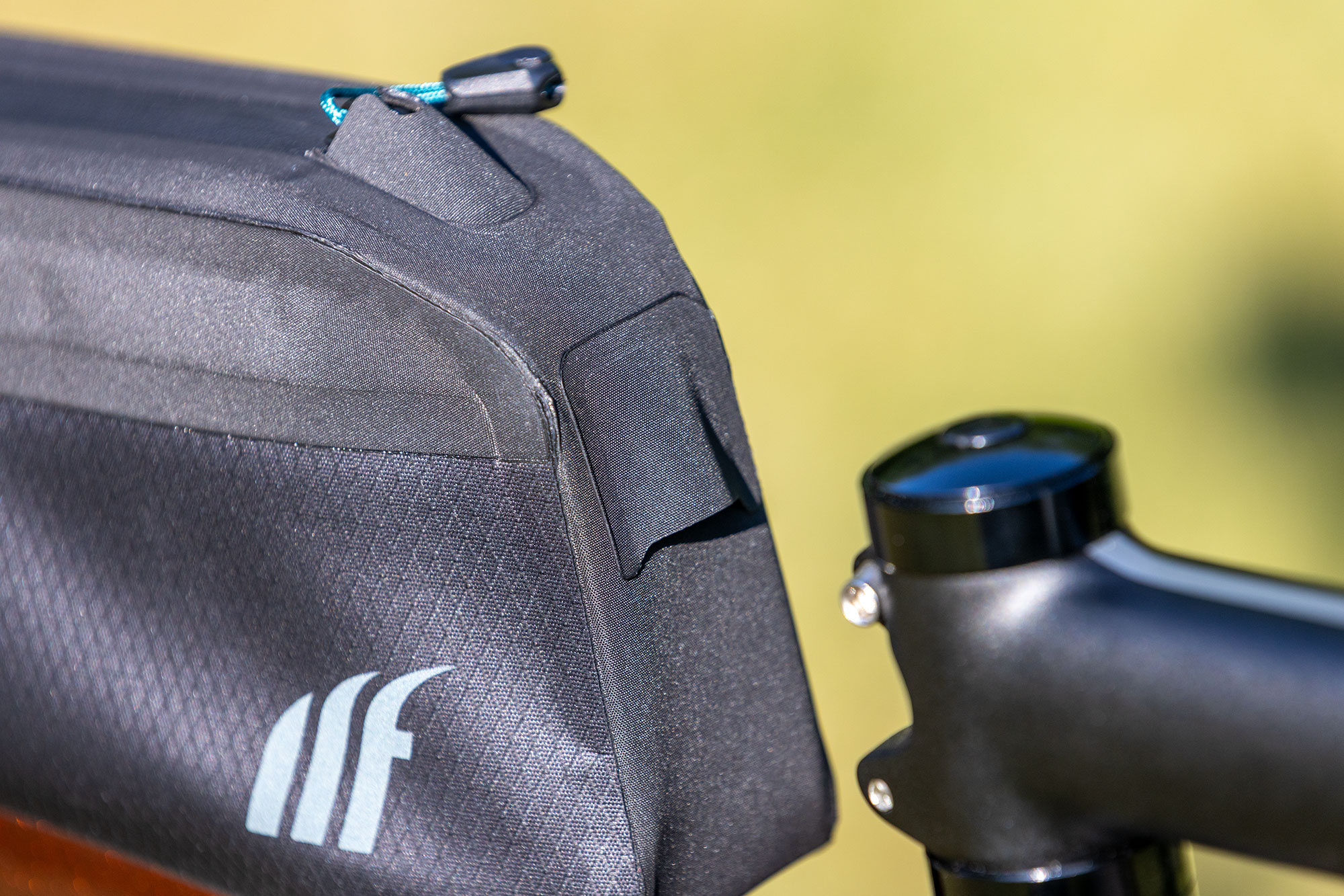 Weatherproof hooded cable port at the front of the Tailfin Long Top Tube Bag
