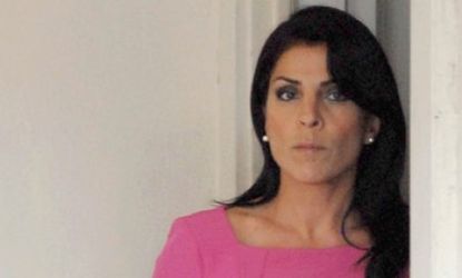 Jill Kelley leaves her home on Nov. 13: Kelley and her husband, a doctor, apparently bankrupted their cancer charity after less than a year.