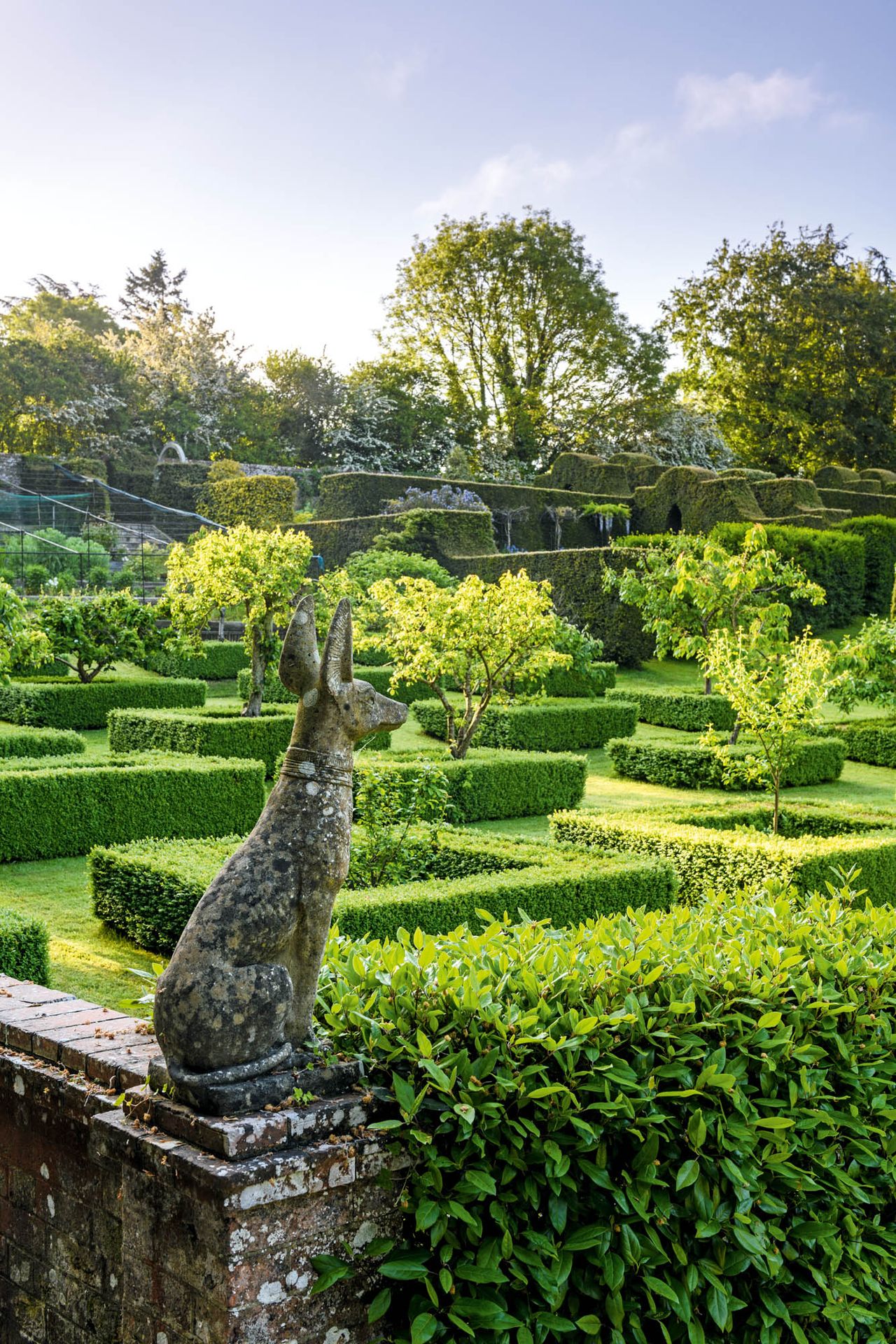 Framed by a grid of immaculately clipped low box, 25 fruit trees are backed by dark yew hedges. The garden at West Lavington Manor, Wiltshire, as photographed by Jason Ingram.