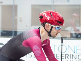 Tom riding in the wind tunnel wearing an aero helmet