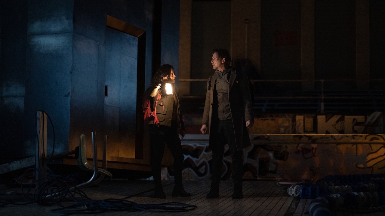 Alice Braga and Jimmi Simpson with a lantern in the dark in Dark Matter Season 2