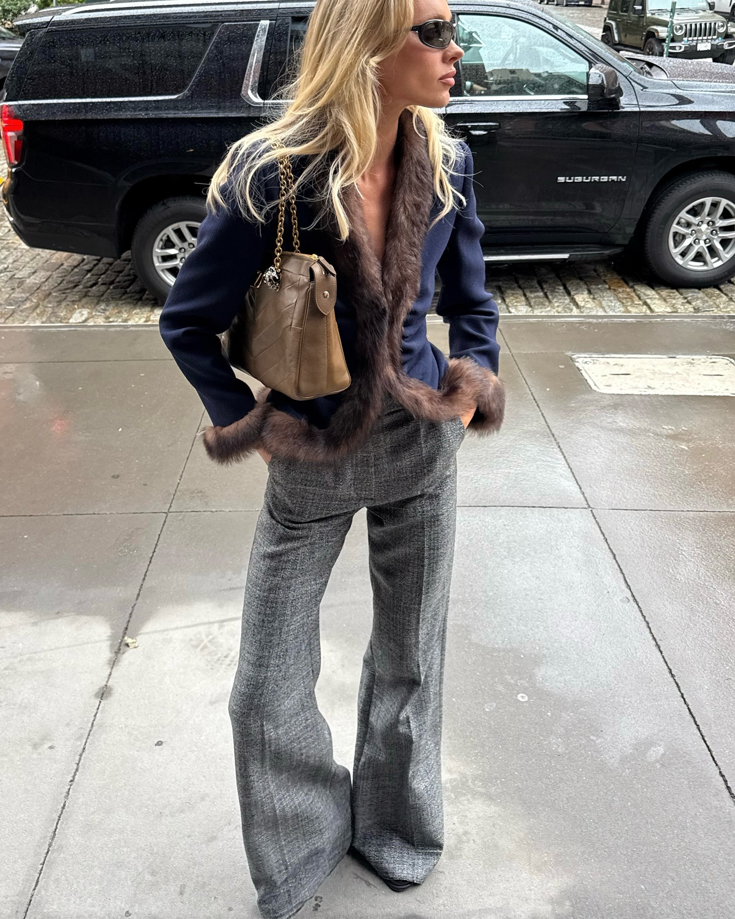 Elsa Hosk wearing a navy jacket and gray pants in NYC