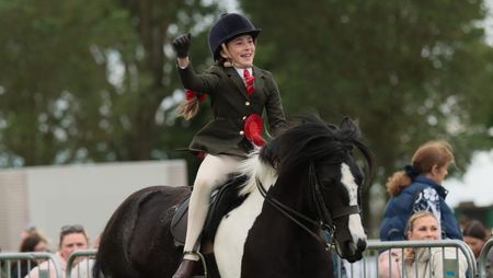 Matilda Mason punches the air as she and Flash Dance canter from the ring having won the Lincolnshire HOYS junior coloured qualifier