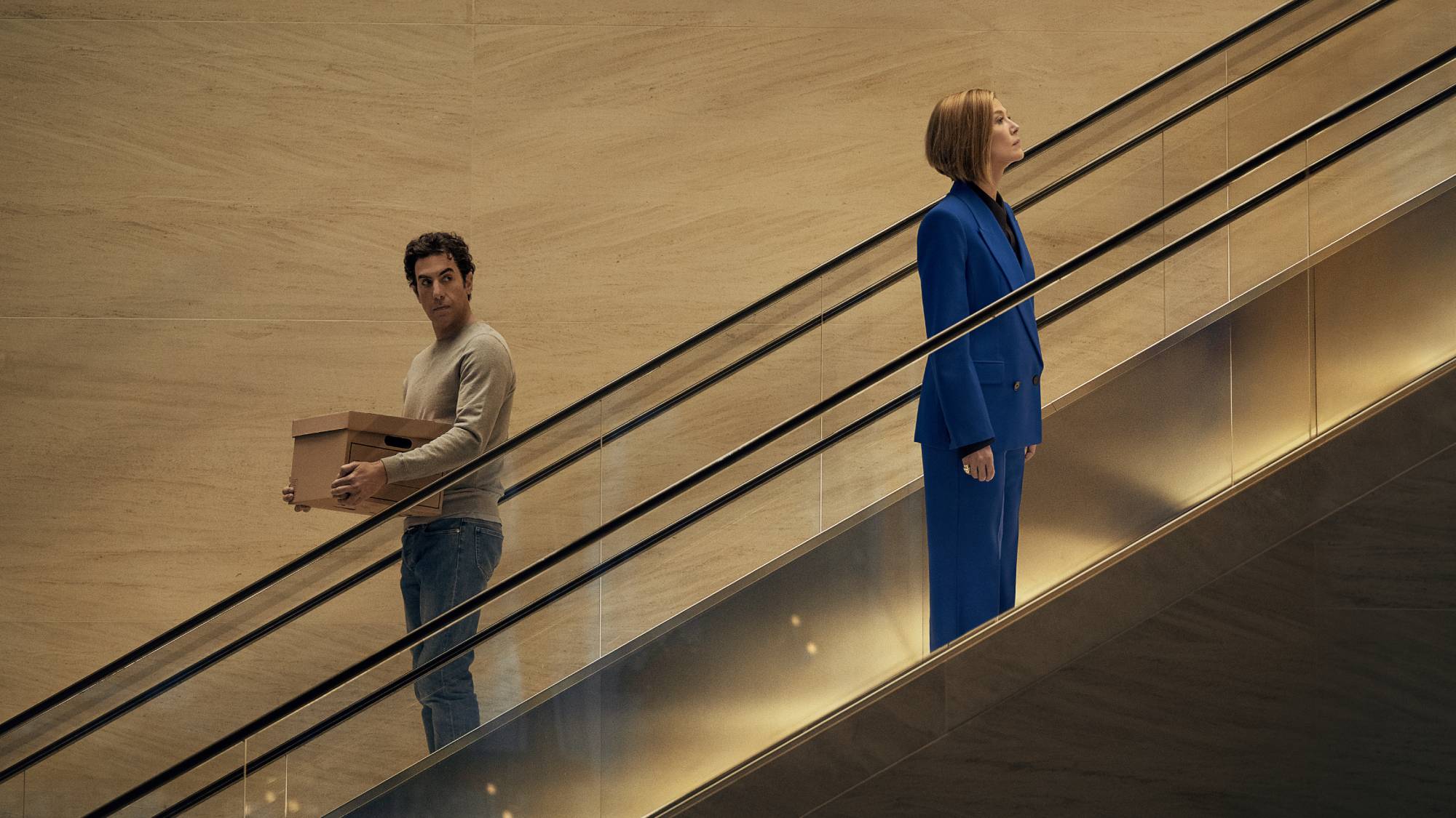 (L-R) Sacha Baron Cohen as Damien Sachs and Rosamund Pike as Alex Fox in "Ladies First"