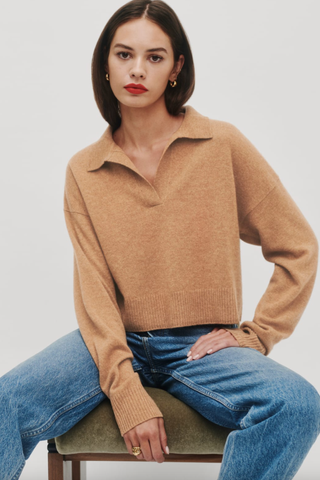 Models wears camel colour jumper with collar and jeans