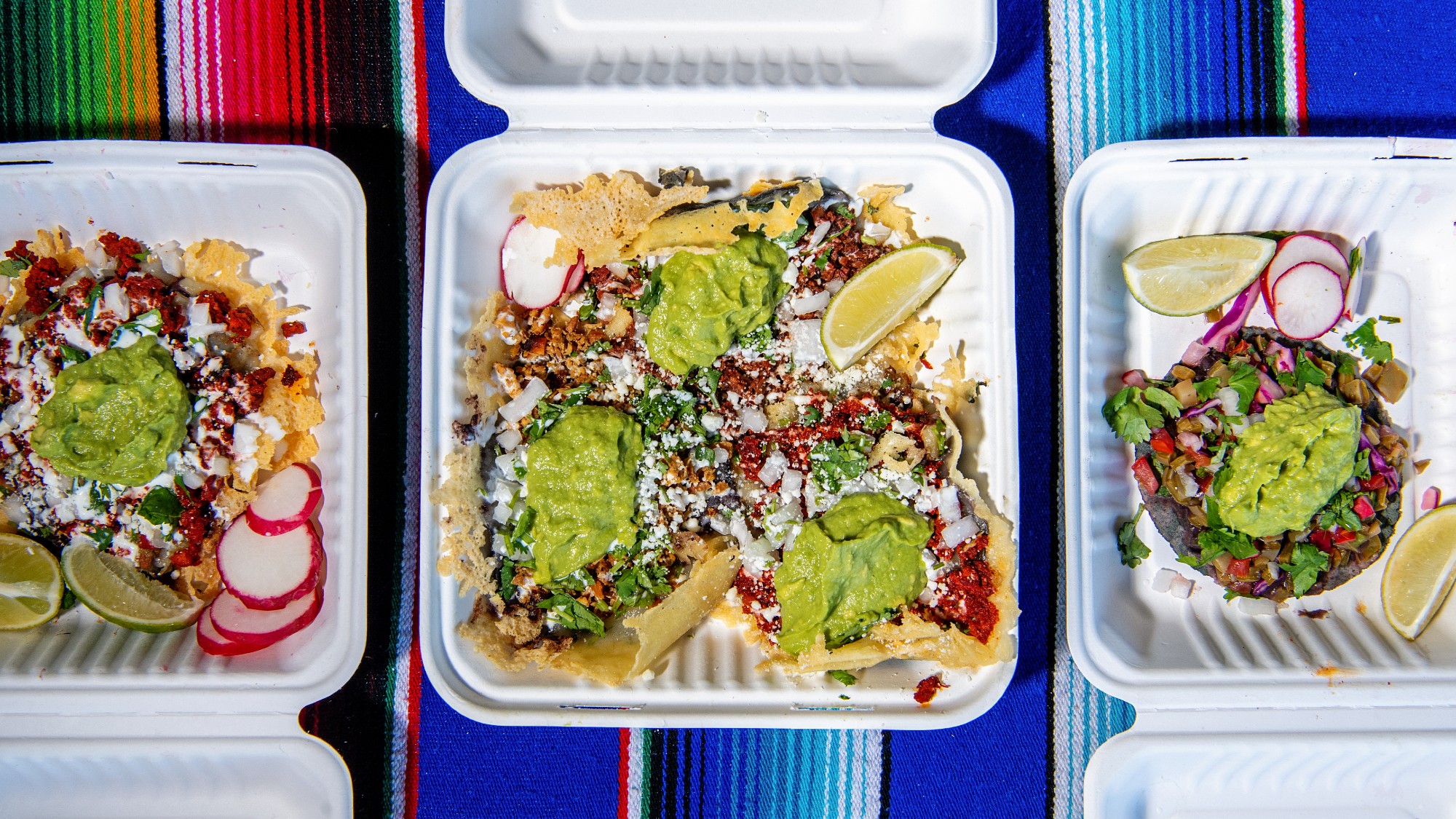 Three styrofoam boxes of tacos