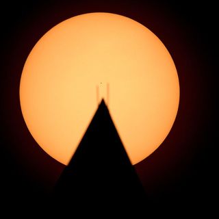 Mercury transits the sun, as seen behind the Washington Monument, on Nov. 11, 2019.