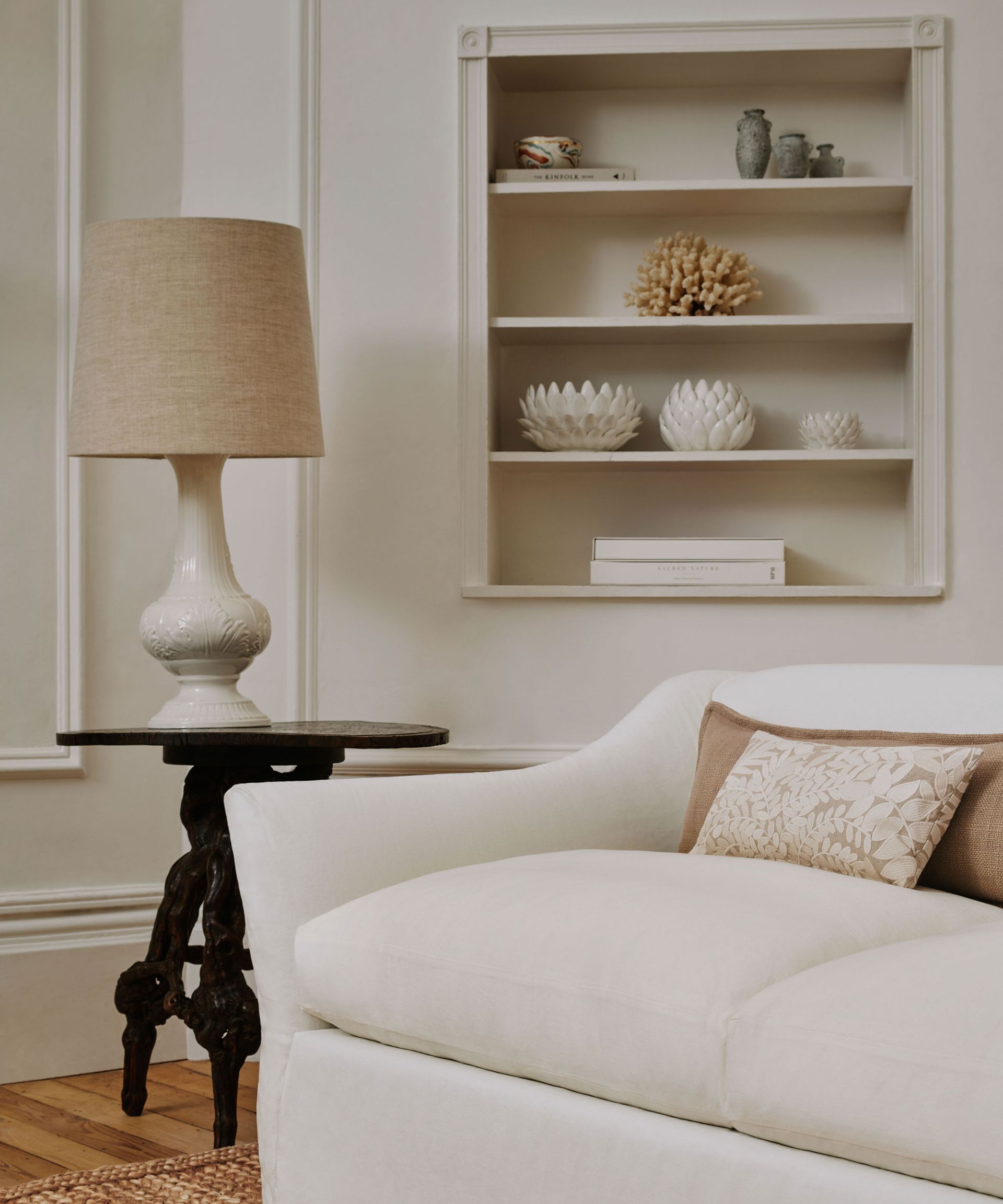 white linen sofa with wood side table and shelves alcove