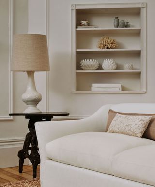white linen sofa with wood side table and shelves alcove