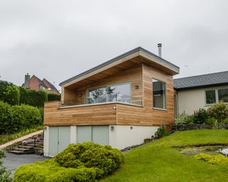 Timber clad extension with balcony to double garage of bungalow