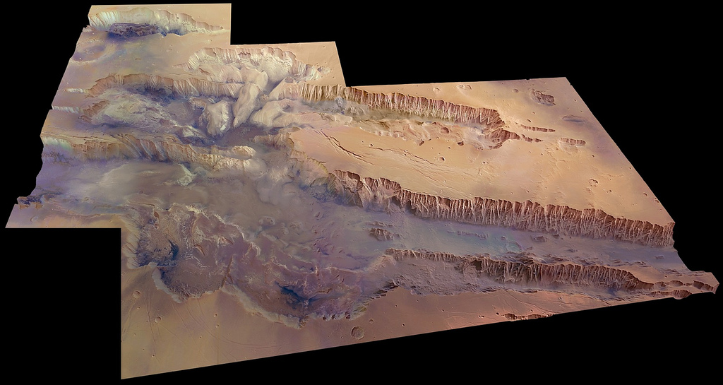 Valles Marineris, seen at an angle of 45 degrees to the surface in near-true colour and with four times vertical exaggeration. The image covers an area of 630 000 sq km with a ground resolution of 100 m per pixel. The digital terrain model was created from 20 individual HRSC orbits, and the colour data were generated from 12 orbit swaths. The largest portion of the canyon, which spans right across the image, is known as Melas Chasma. Candor Chasma is the connecting trough immediately to the north, with the small trough Ophir Chasma beyond. Hebes Chasma can be seen in the far top left of the image.