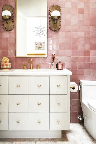 pink bathroom with gold bathroom mirror