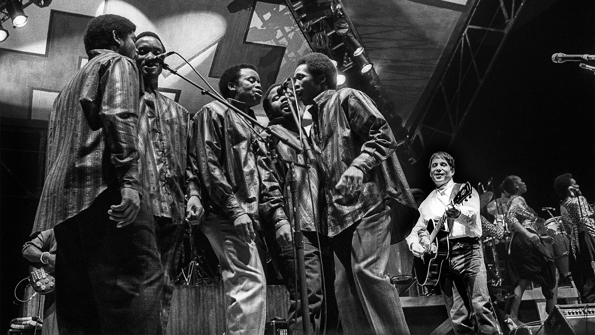 Paul Simon performs live on stage with fellow musicians from the Graceland tour at Ahoy in Rotterdam, Netherlands on 1st February 1987.