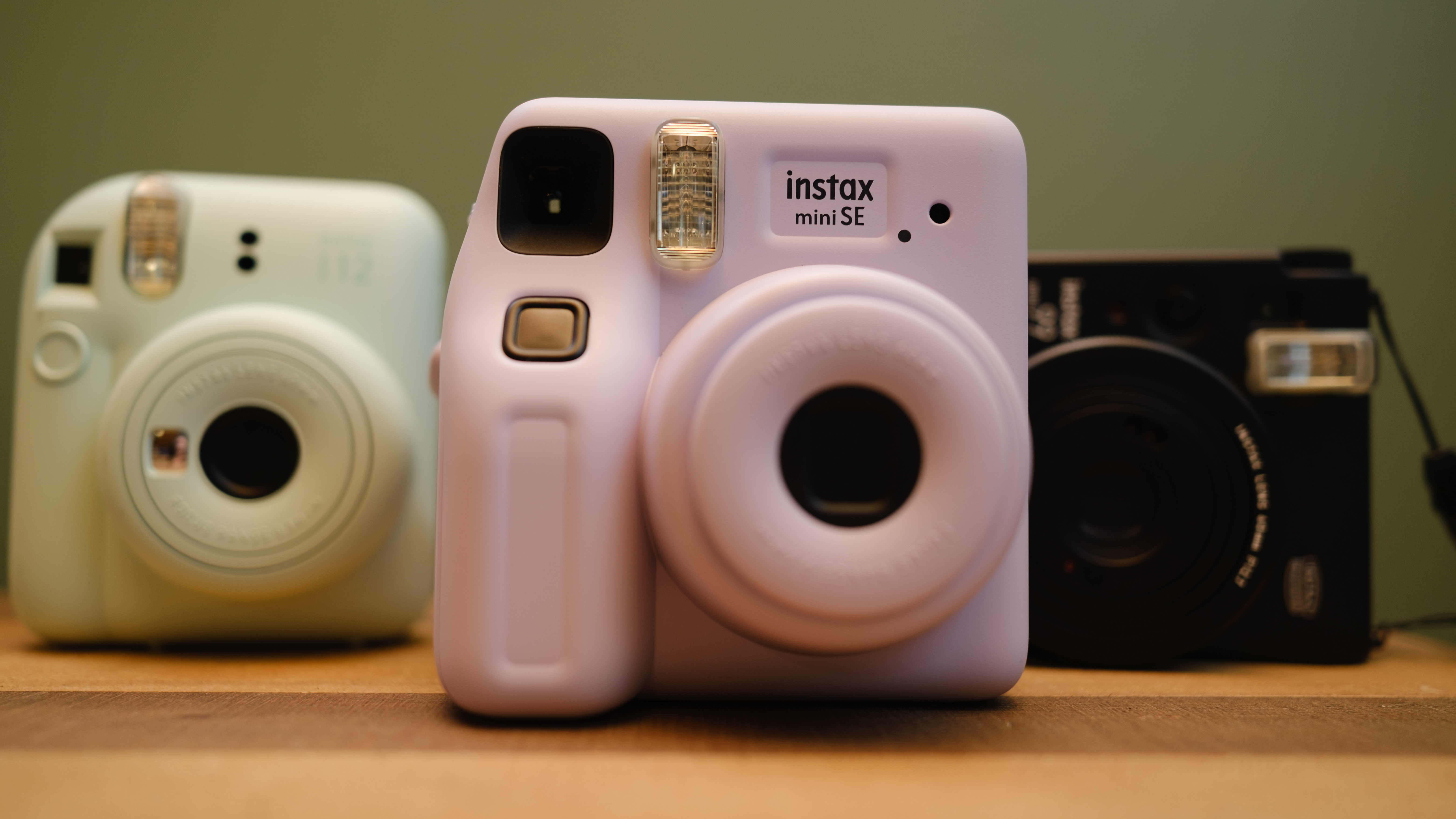 The Fujifilm Instax Mini SE (center) with the Instax Mini 12 (left) and Mini 99 (right)