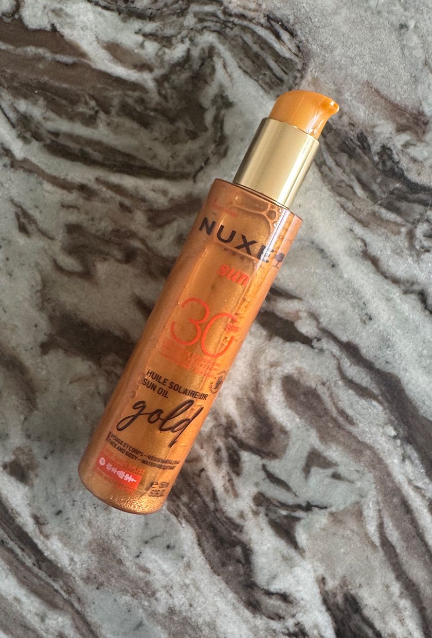 Nuxe Shimmer SPF 30 on marble table