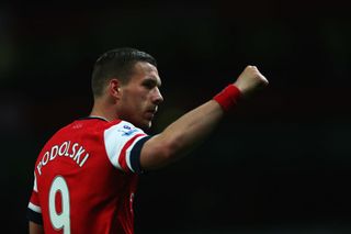 Lukas Podolski of Arsenal celebrates as he scores their third goal during the Barclays Premier League match between Arsenal and West Ham United at Emirates Stadium on April 15, 2014 in London, England.