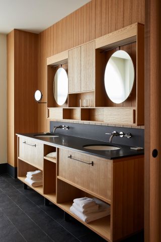 Image of bathroom with 2 sink, 2 mirror, towels etc