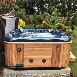 blue hot tub in garden area