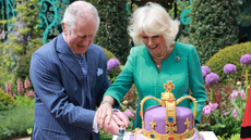 King Charles and Queen Camilla cut into a cake in the shape of a crown