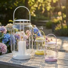 IKEA TOFSAND lanterns on a table in a garden as dusk is falling