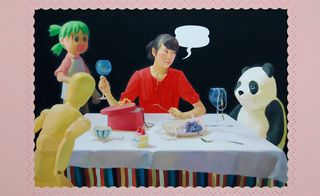 A woman sitting at a dinner table with a panda, a cartoon girl, and a poseable wooden figure