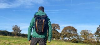 Man wearing Vango Hex Rolltop 25L backpack