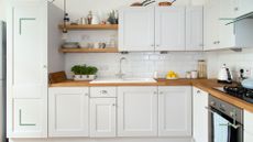 Cream kitchen with plenty of cabinets to support a guide on how to clean grease off kitchen cabinets