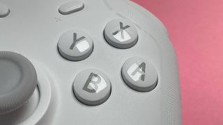 The GameSir T4 Cyclone game controller for iOS and macOS against a pink background.