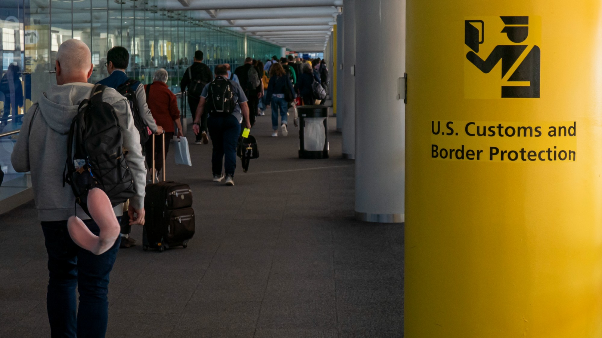 U.S. Customs and Border Protection CBP sign, inscription and symbol in yellow background in Newark Liberty International Airport EWR serving the New York Metropolitan area with arriving passenger walking in the terminal towards the immigration passport control. United States Customs and Border Protection is the largest federal law enforcement agency of the United States Department of Homeland Security with agents and officers, it's the primary border control organization. Newark, United States of America on November 2024 (Photo by Nicolas Economou/NurPhoto via Getty Images)