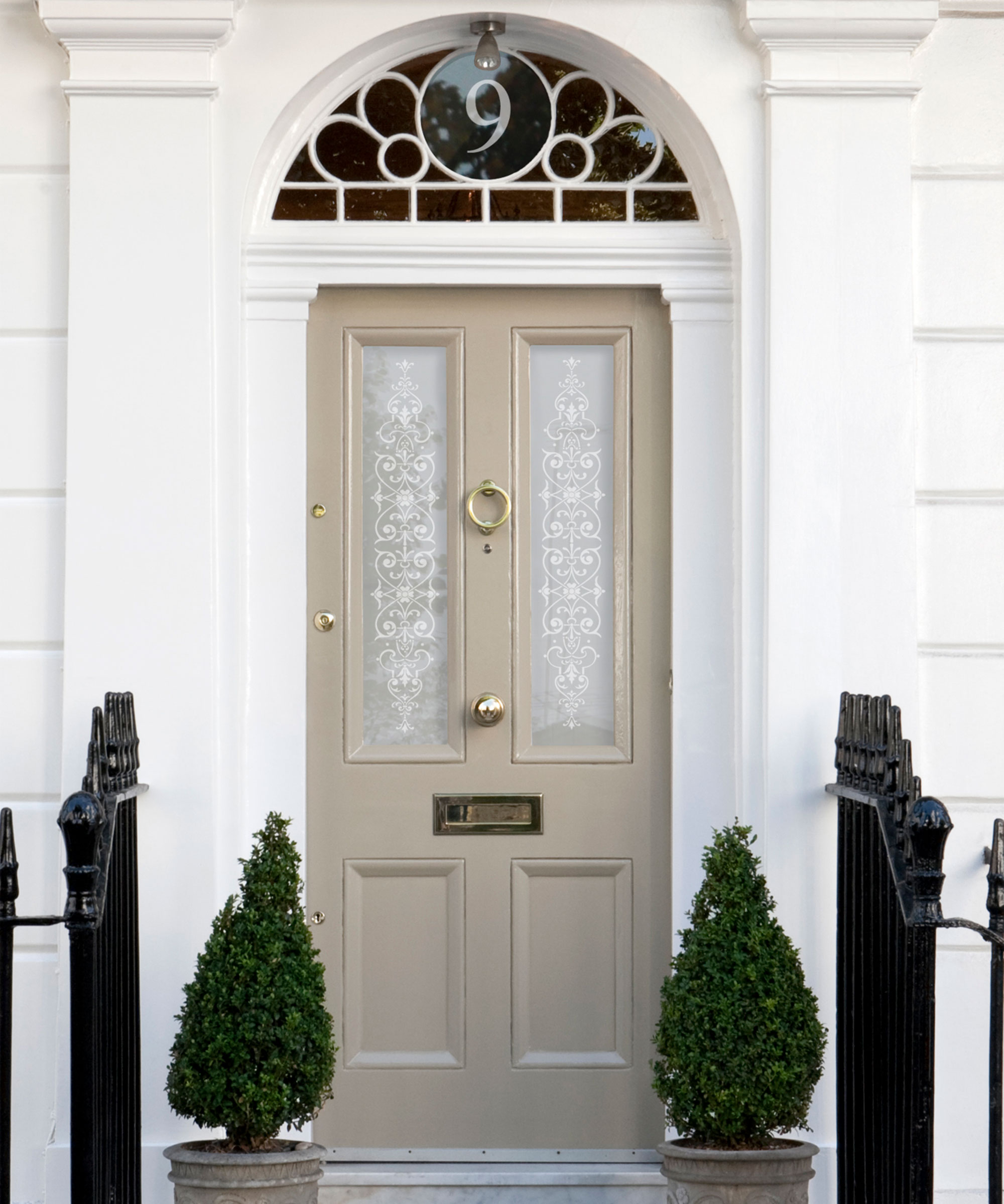 beige two panel front door with brass hardware