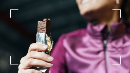 Woman eating chocolate-covered protein bar after wondering are protein bars good for weight loss