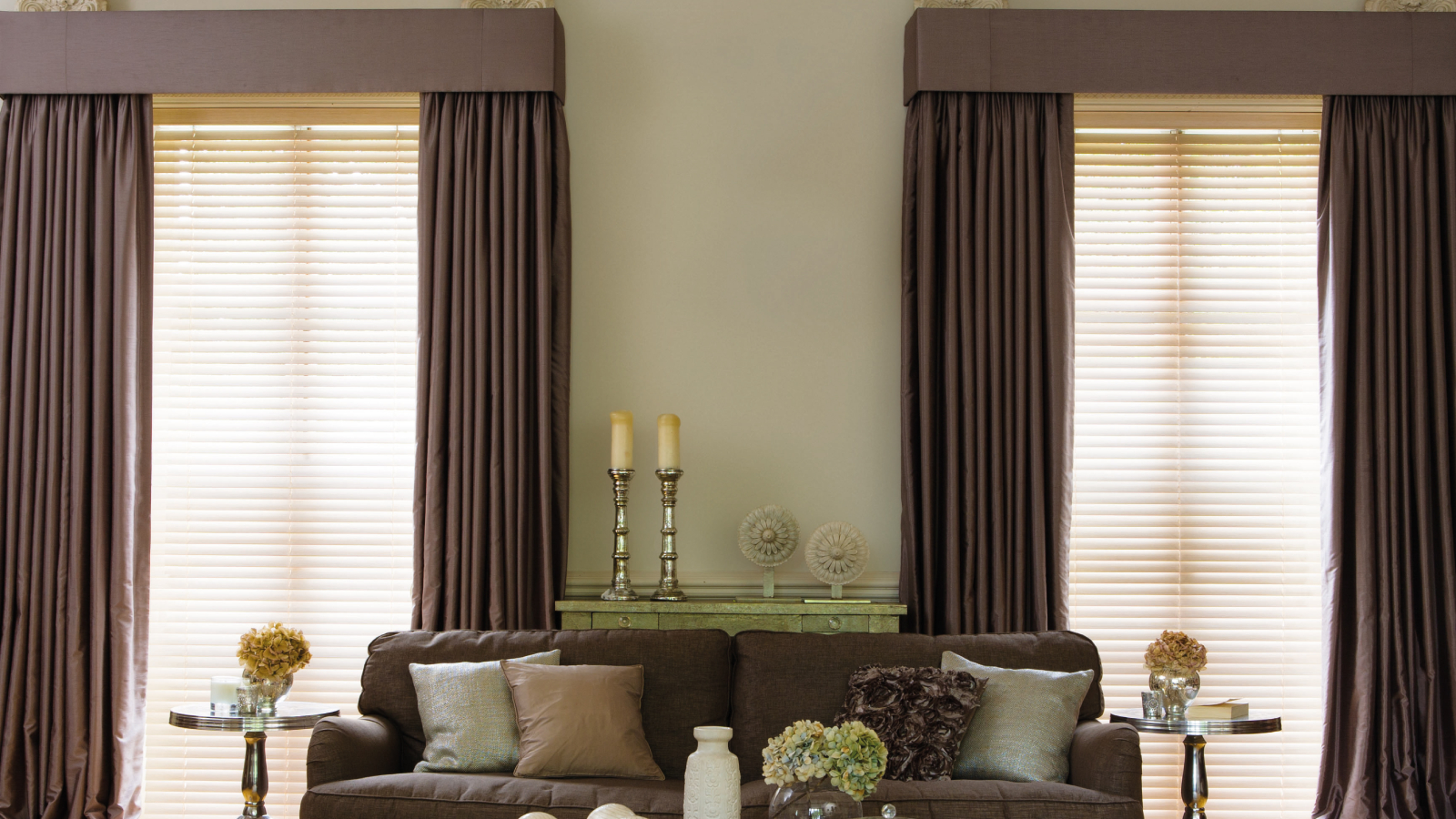 living room with two large windows layered with blinds and curtains