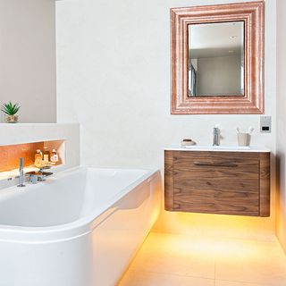 compact bathroom with white bath tub